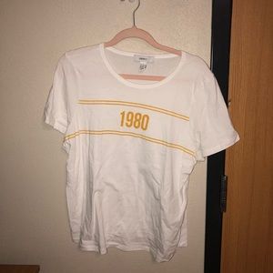 Large white T with “1980” print